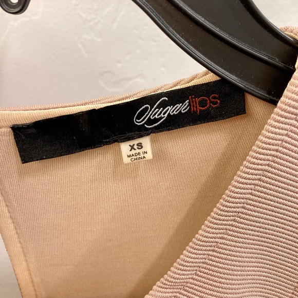 Tan bandage dress with bright orange and black waist detailing. - Picture 7 of 7